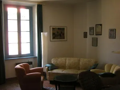a living room with a couch and chairs and a window at 