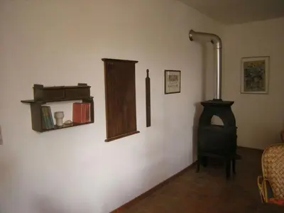 a room with a wood stove and a chair at 
