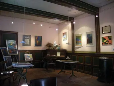 a room with a table and paintings on the wall at 