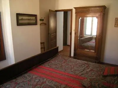a room with a bed and a door with a mirror at 
