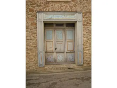a stone building with a large wooden door at 