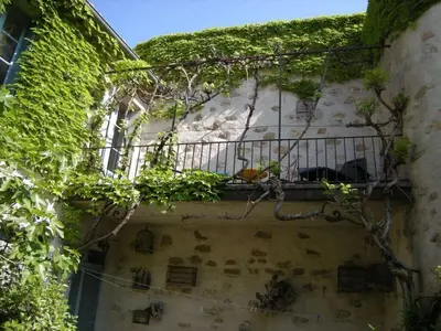a building with a balcony with plants on it at 