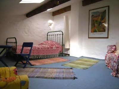 a room with a bed and a table and chairs at 