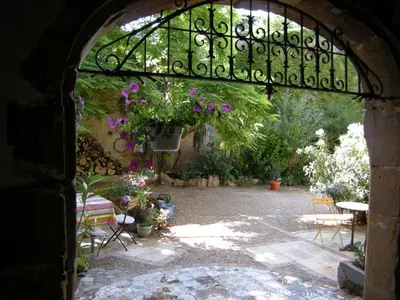 an archway with a bunch of flowers in a yard at 