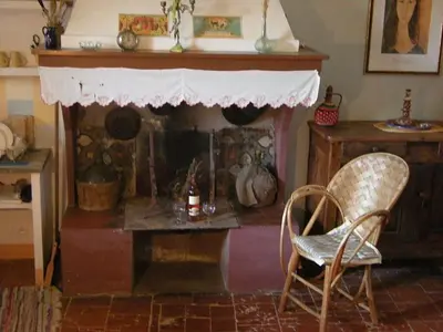 a living room with a fireplace and a chair at 