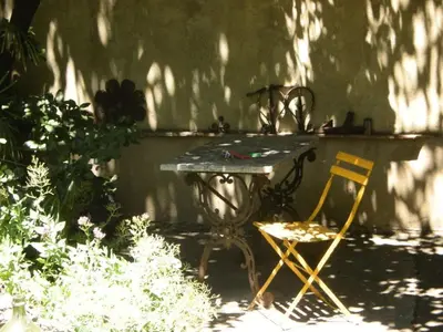 a table and a yellow chair in a garden at 