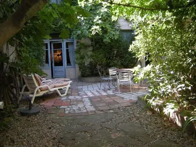 a patio with chairs and a table in front of a house at 