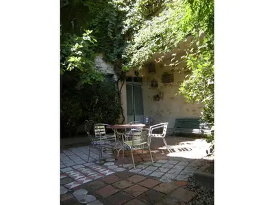 a patio with a table and chairs in front of a building at 