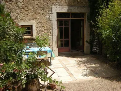 a door to a stone building with a table in front of it at 