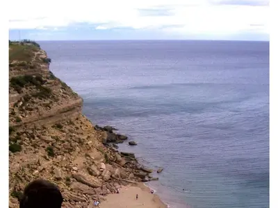 a person standing on a cliff overlooking a beach at Maison Marianne Comfortable holiday residence in Ferrals-lès-Corbières