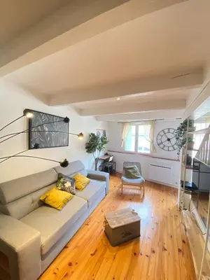 a living room with a couch and a table at Maison de l'Ancienne Porte Neuve in Narbonne
