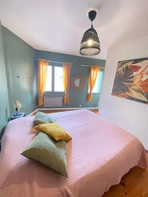 a bedroom with a large bed with yellow pillows at Maison de l'Ancienne Porte Neuve in Narbonne