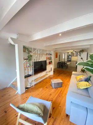 a living room with a couch and a tv at Maison de l'Ancienne Porte Neuve in Narbonne