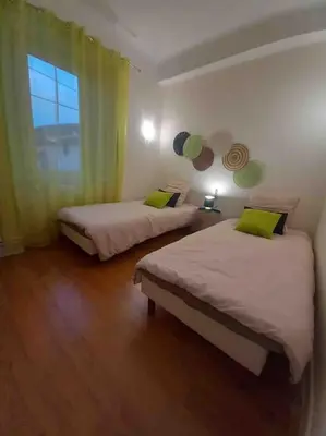 a room with two beds and a window in it at La Coumereille in Belcaire
