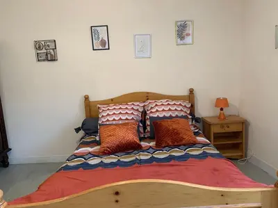a bed with pillows on it in a bedroom at La Coumereille in Belcaire