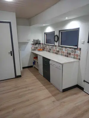 a large kitchen with a counter and a window at La Coumereille in Belcaire