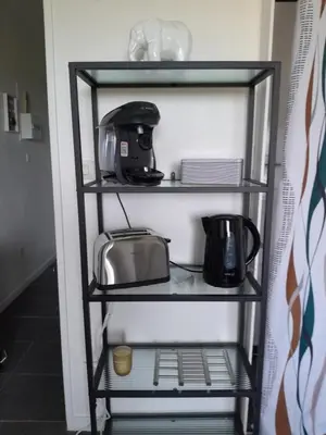 a shelf with appliances on it in a kitchen at Studio Balcon Narbonne Centre in Narbonne