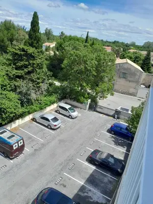 an overhead view of a parking lot with cars parked at Studio Balcon Narbonne Centre in Narbonne