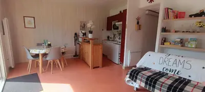 a room with a kitchen and a table with a bed at Vue exceptionnelle tout en haut des montagnes, dépaysement total ! in Camurac