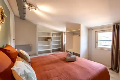 a bedroom with a large bed and a window at Le Canopé - Duplex Confort, Hypercentre, 2 Salles d'eau in Castres
