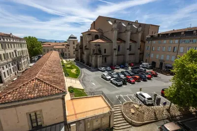 a city with cars parked in a parking lot at Le Canopé - Duplex Confort, Hypercentre, 2 Salles d'eau in Castres
