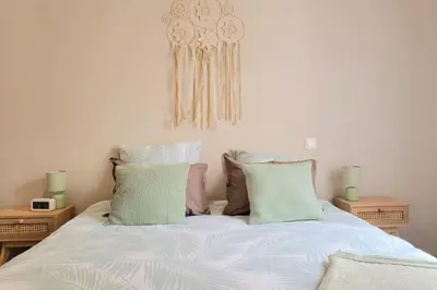 a bedroom with a bed with two pillows at Superbe T2 cosy plein centre in Narbonne