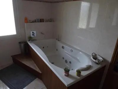 a white bath tub in a bathroom with a window at Chambres Sainte Anne in Carcassonne