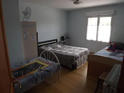 a bedroom with two beds and a window at Chambres Sainte Anne in Carcassonne