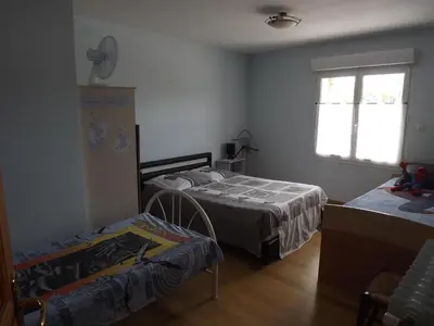 a bedroom with two beds and a window at Chambres Sainte Anne in Carcassonne