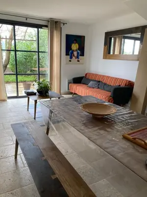 a living room with a couch and a table at Saint laurent de la cabrerisse Rivière proche Lagrasse in Saint-Laurent-de-la-Cabrerisse