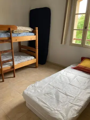 a bedroom with a bed and a bunk bed with a ladder at Saint laurent de la cabrerisse Rivière proche Lagrasse in Saint-Laurent-de-la-Cabrerisse