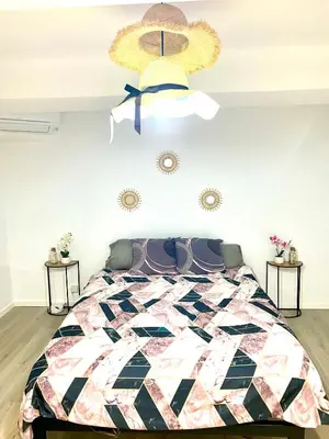a bedroom with a large bed and a ceiling at La pinéa in Port-la-Nouvelle