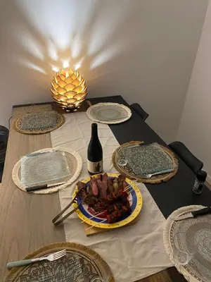 a table with a plate of food and a bottle of wine at La pinéa in Port-la-Nouvelle