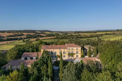 an aerial view of a large house with a river at Le Domaine de Camboyer, The Originals Collection in Montferrand
