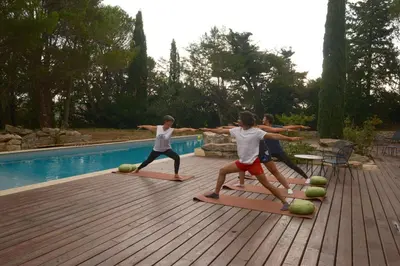 a group of children playing on mats by a pool at Le Domaine de Camboyer, The Originals Collection in Montferrand