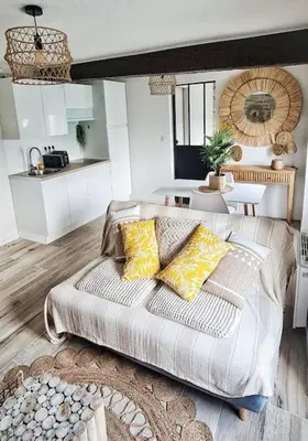 a living room with a couch and a kitchen at 4-Pieds Cité - Barbacane - Historique - Romantique - Clim in Carcassonne