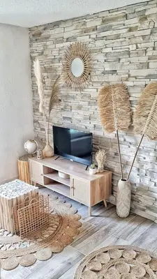 a living room with a tv and a stone wall at 4-Pieds Cité - Barbacane - Historique - Romantique - Clim in Carcassonne
