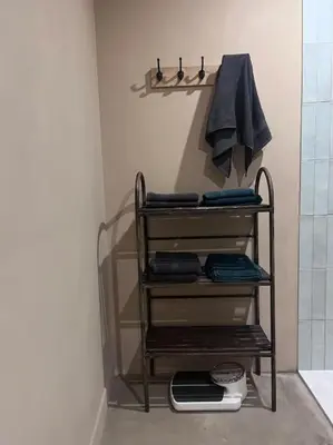a towel rack in a bathroom with a shower at Maison Bacchus, gîte insolite dans cuve à vin in Caves