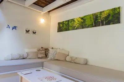 a living room with a couch and a table at Secluded home in Le Caunil in Salvezines