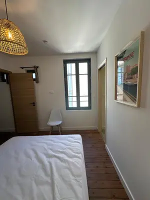 a bedroom with a white bed and a window at T2 Ed Warner in Narbonne