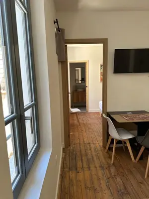 a living room with a table and a window at T2 Ed Warner in Narbonne