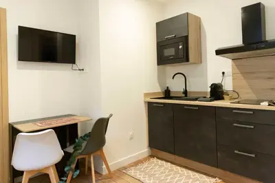 a kitchen with a sink and a microwave at T2 Ed Warner in Narbonne