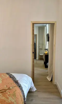 a bedroom with a bed and a hallway with a bathroom at Thomas Price Appart in Narbonne