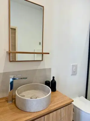 a bathroom with a sink and a mirror on a counter at Thomas Price Appart in Narbonne