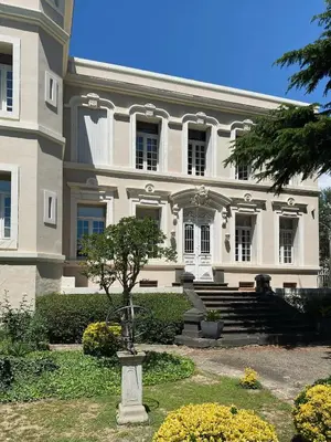 a large white building with a tree in front of it at Château Suite in Saint-Marcel