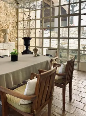 a large room with a table with chairs and a large window at Château Suite in Saint-Marcel