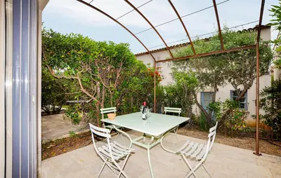 a table and chairs sitting on a patio at 2 Bedroom Awesome Home In Saint-Laurent-De-La-Ca in Saint-Laurent-de-la-Cabrerisse