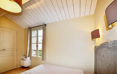 a bedroom with a bed and a window at 2 Bedroom Awesome Home In Saint-Laurent-De-La-Ca in Saint-Laurent-de-la-Cabrerisse