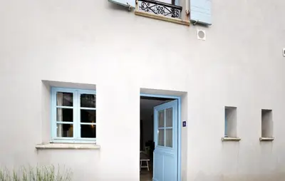 a white house with a blue door at 2 Bedroom Awesome Home In Saint-Laurent-De-La-Ca in Saint-Laurent-de-la-Cabrerisse