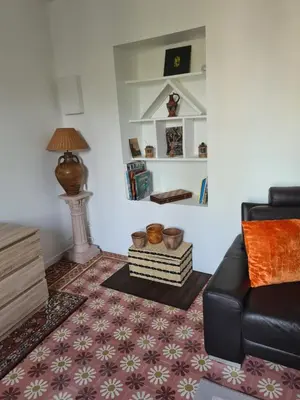 a living room with a couch and a table at Appartement rénové avec jardin in Cuxac-dʼAude
